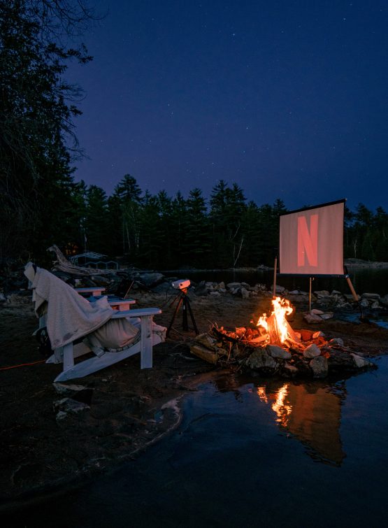 Movie screen outdoors with chairs in front